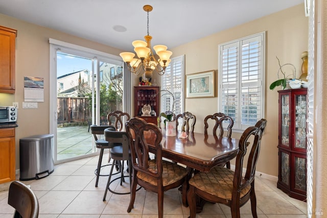 dining room featuring plenty of natural light, a chandelier, and light tile patterned floors