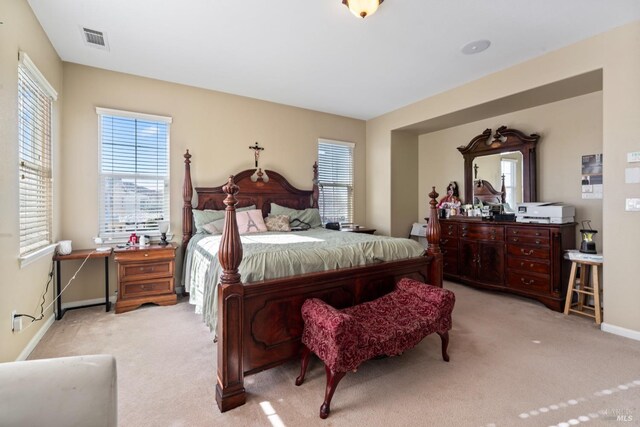 bedroom featuring light carpet