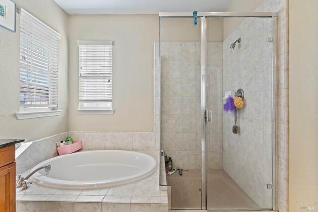 bathroom featuring vanity, tile patterned floors, and separate shower and tub