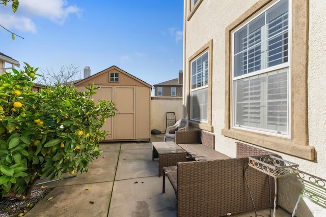 view of patio with outdoor lounge area and a storage shed