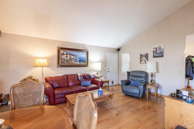 living room featuring lofted ceiling and light wood-type flooring