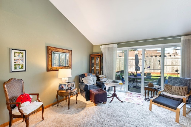 sitting room with carpet flooring and vaulted ceiling