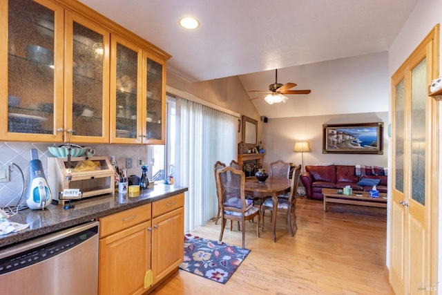 kitchen featuring dishwasher, lofted ceiling, ceiling fan, decorative backsplash, and light wood-type flooring