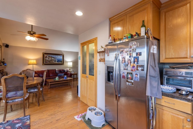 kitchen with ceiling fan, stainless steel refrigerator with ice dispenser, and light hardwood / wood-style flooring