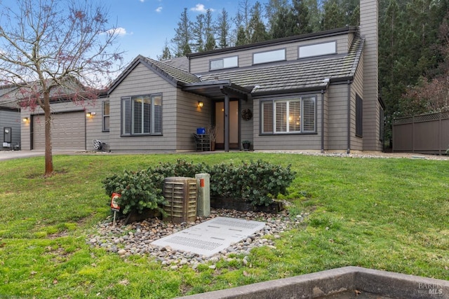 view of front facade with a garage and a front lawn