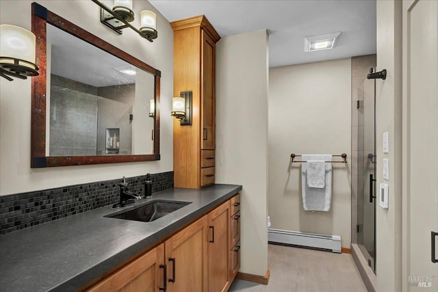 bathroom featuring an enclosed shower, a baseboard heating unit, vanity, tasteful backsplash, and toilet