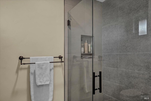 bathroom featuring a shower with shower door