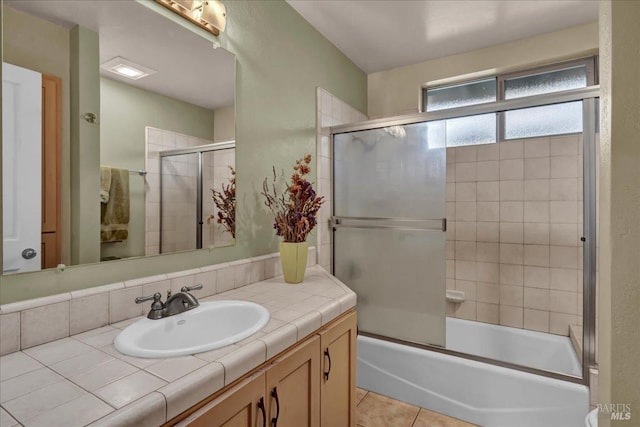 bathroom featuring bath / shower combo with glass door, vanity, and tile patterned flooring