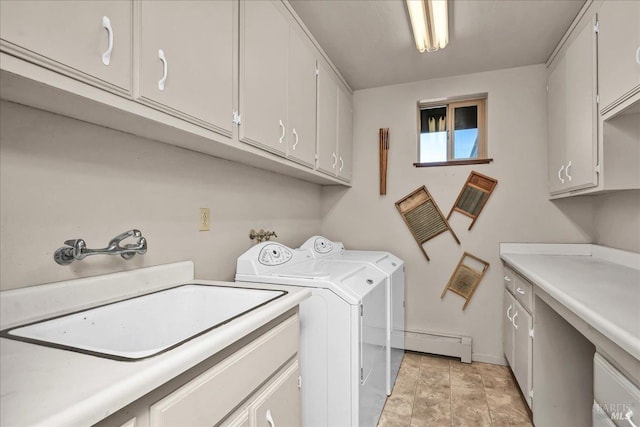 washroom with cabinets, sink, independent washer and dryer, and a baseboard radiator