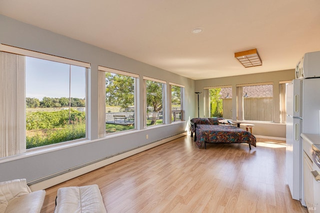 sunroom / solarium featuring a baseboard radiator