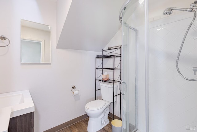 bathroom featuring hardwood / wood-style floors, an enclosed shower, vanity, and toilet