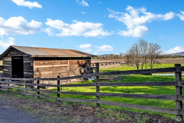 view of horse barn featuring a rural view