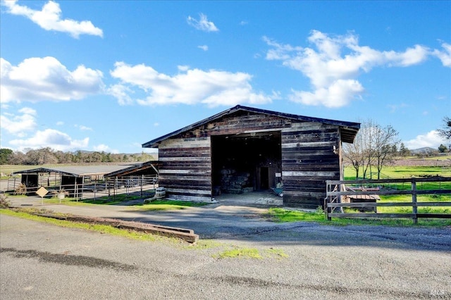 view of outdoor structure with a rural view