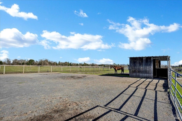 view of yard with a rural view and an outbuilding