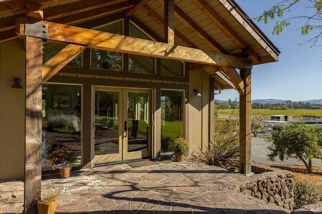 exterior space with french doors, a patio area, and a mountain view