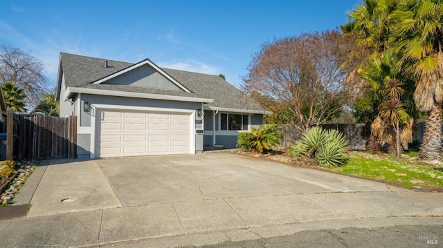 ranch-style home with a shingled roof, fence, driveway, and an attached garage