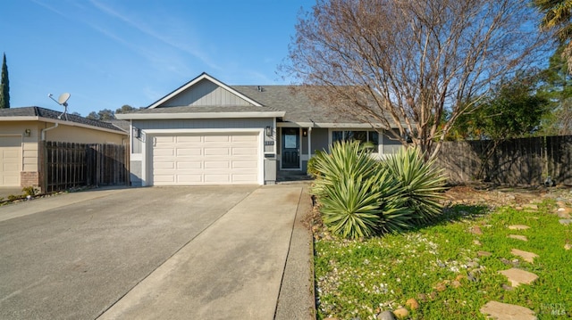 single story home with a garage, fence, and driveway