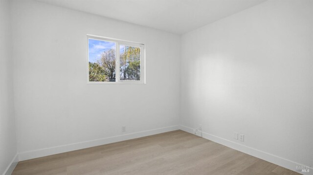 unfurnished room with light wood-style floors and baseboards