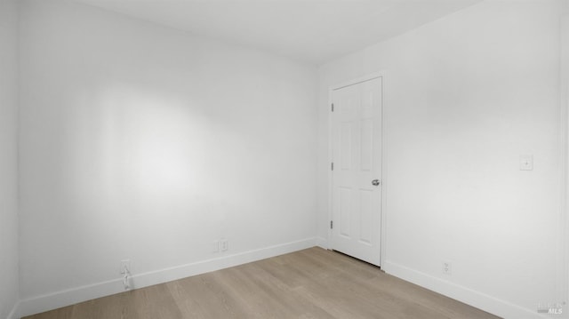 unfurnished room with light wood finished floors and baseboards