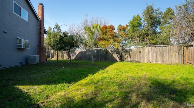 view of yard featuring a fenced backyard and central air condition unit