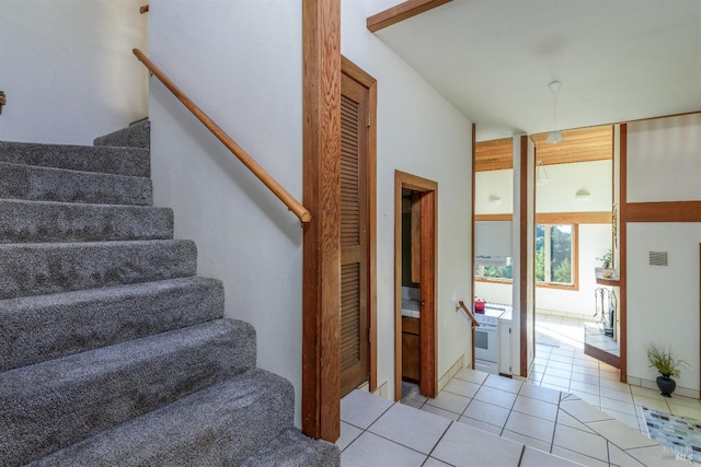 staircase featuring tile patterned floors