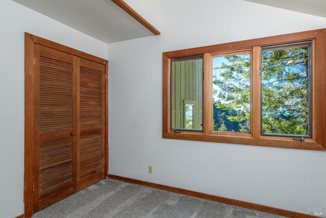 unfurnished bedroom featuring carpet, baseboards, and a closet