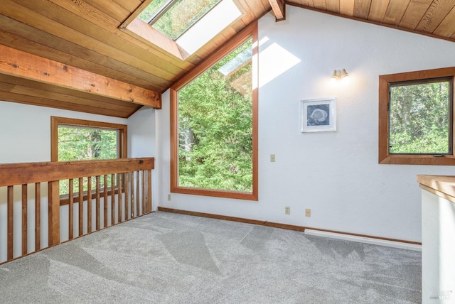 spare room with vaulted ceiling with skylight, carpet, wooden ceiling, and baseboards