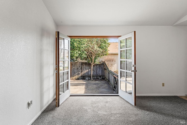 interior space with plenty of natural light, lofted ceiling, carpet floors, and french doors