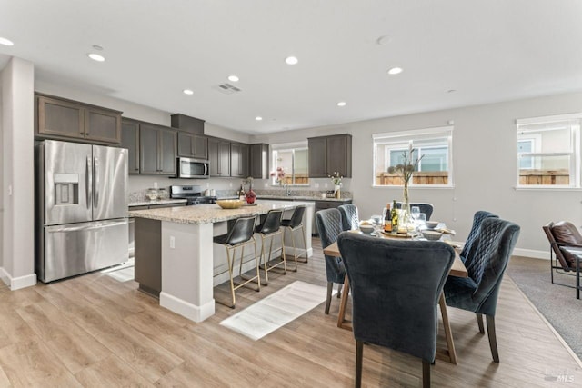 dining room with recessed lighting, visible vents, baseboards, and light wood-style flooring