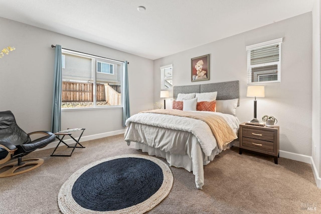 carpeted bedroom featuring baseboards