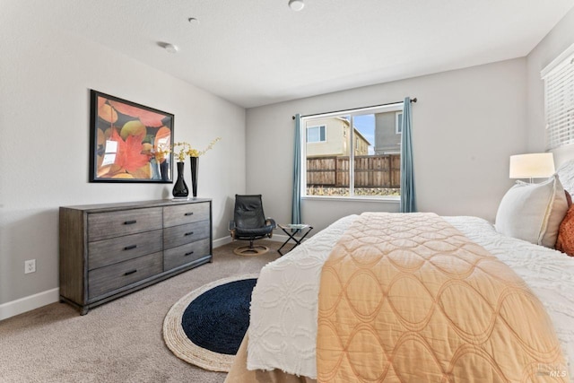 carpeted bedroom featuring baseboards