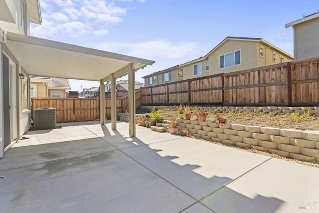 view of patio featuring a fenced backyard and central AC