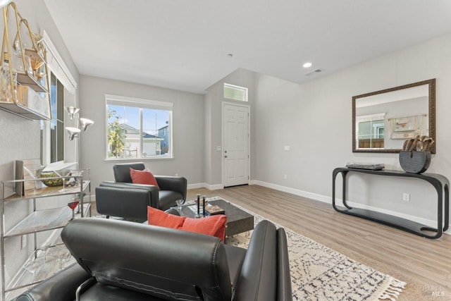 living area featuring visible vents, recessed lighting, wood finished floors, and baseboards