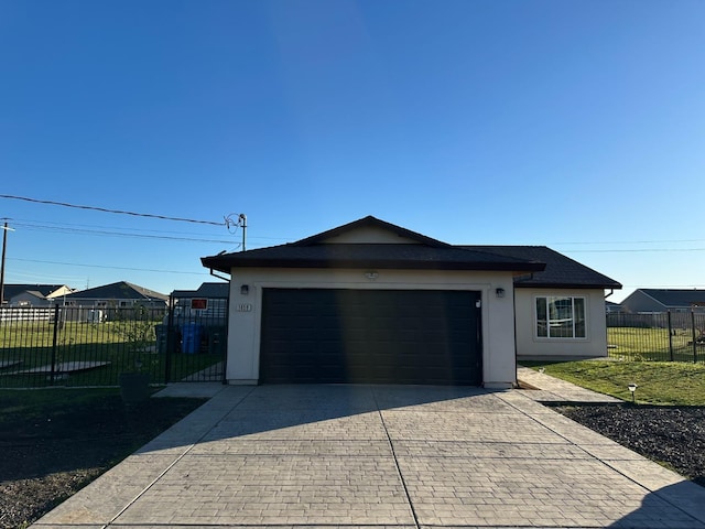 exterior space with a garage and a lawn