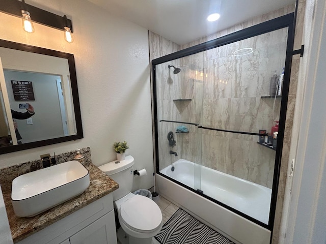 full bathroom with vanity, enclosed tub / shower combo, and toilet