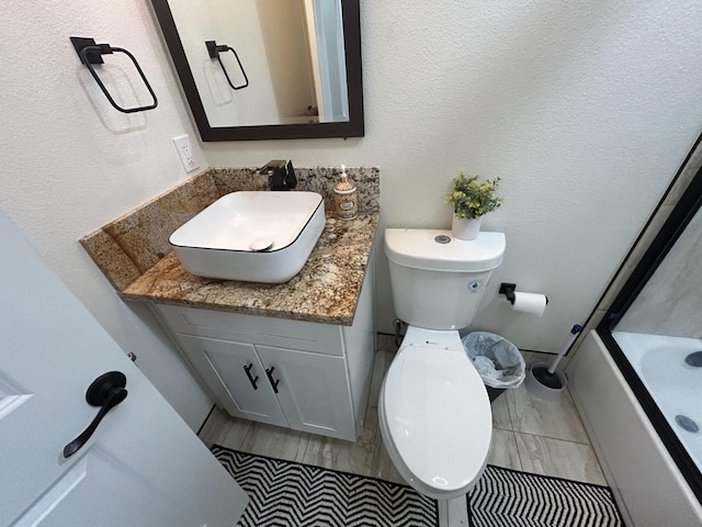 bathroom featuring vanity, wood-type flooring, and toilet