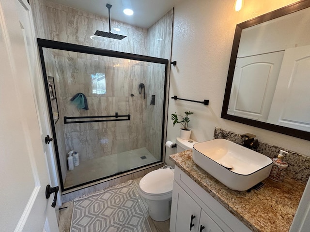 bathroom with vanity, an enclosed shower, and toilet