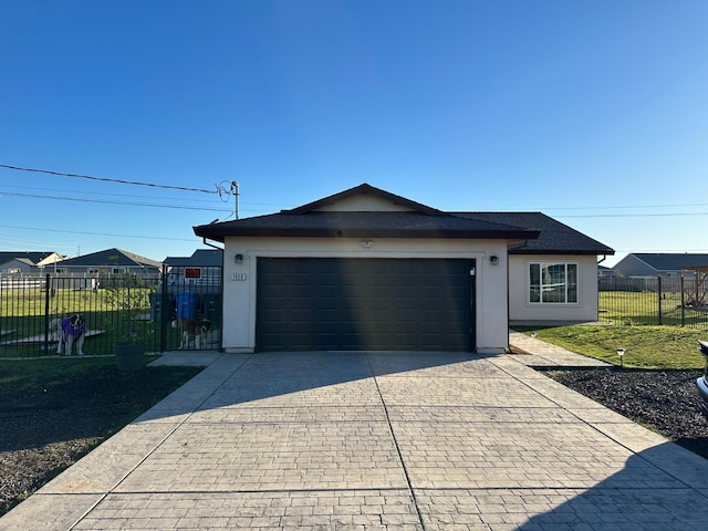 view of front of property featuring a garage and a front lawn