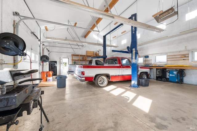 garage with a workshop area and a garage door opener