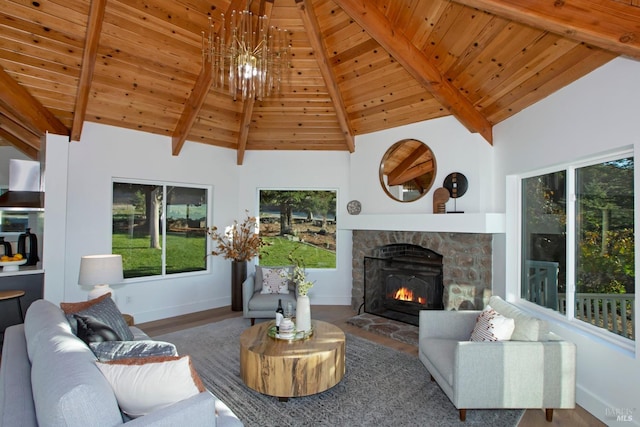 living room with wood ceiling, a notable chandelier, a fireplace, wood-type flooring, and beam ceiling