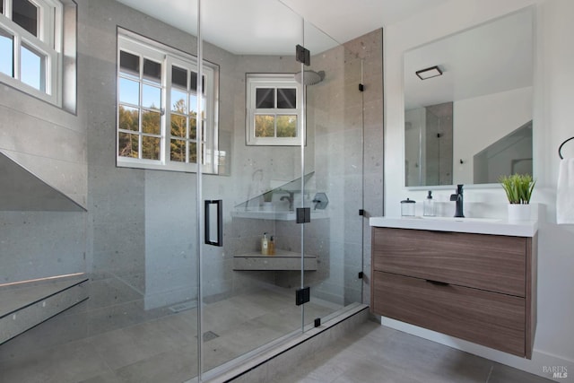 bathroom featuring an enclosed shower, vanity, and tile patterned flooring