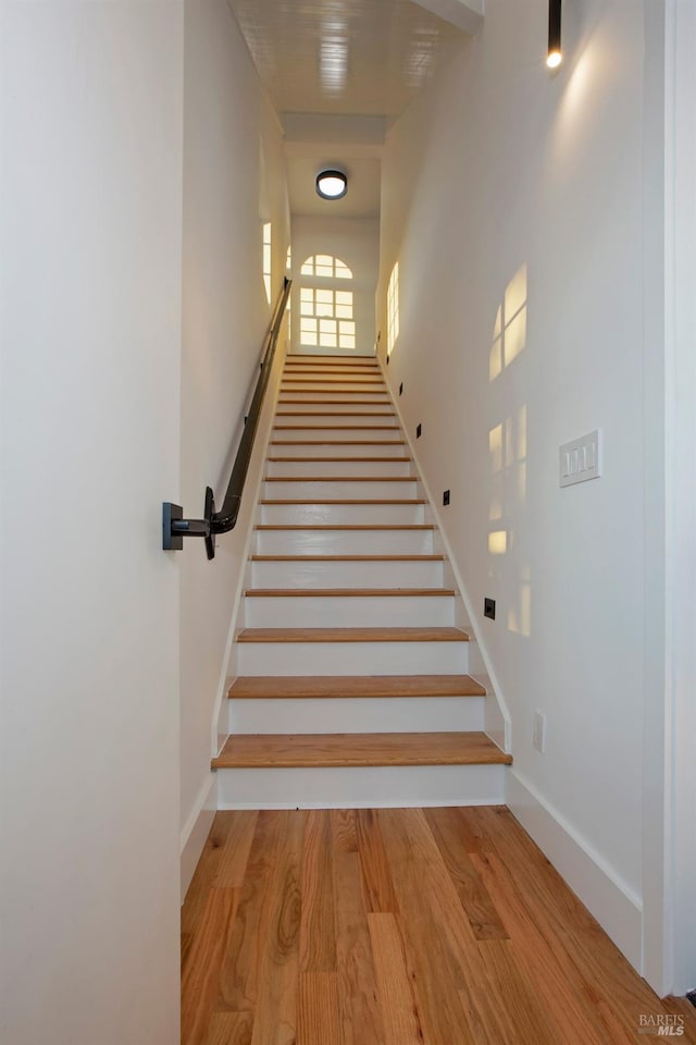 staircase featuring hardwood / wood-style floors