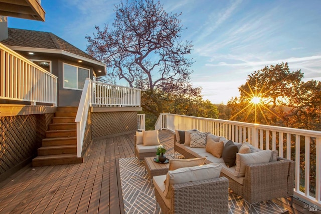 deck at dusk with outdoor lounge area