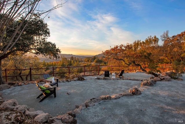 yard at dusk featuring a mountain view