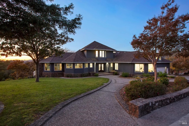 view of front of property featuring a yard and a garage