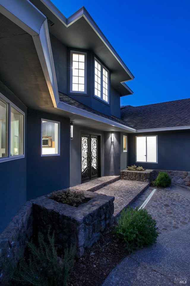 property entrance featuring french doors and a patio