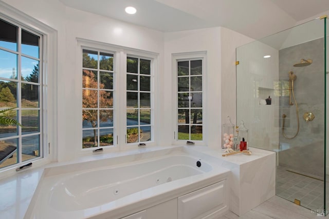 bathroom featuring independent shower and bath