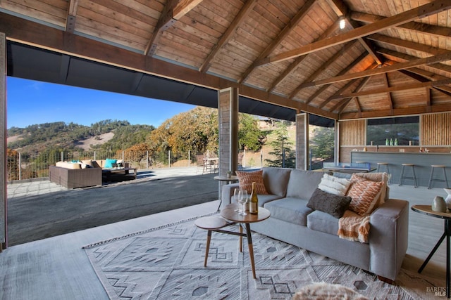 view of patio featuring a mountain view, a gazebo, a bar, and an outdoor living space