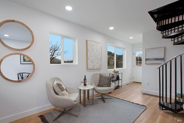 living area featuring a wealth of natural light and light hardwood / wood-style floors