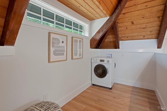 clothes washing area featuring light wood-type flooring, wood ceiling, and washer / clothes dryer